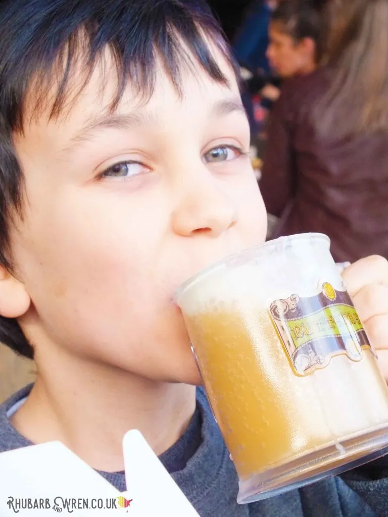 boy drinking stein of butterbeer at the Harry Potter studio tour