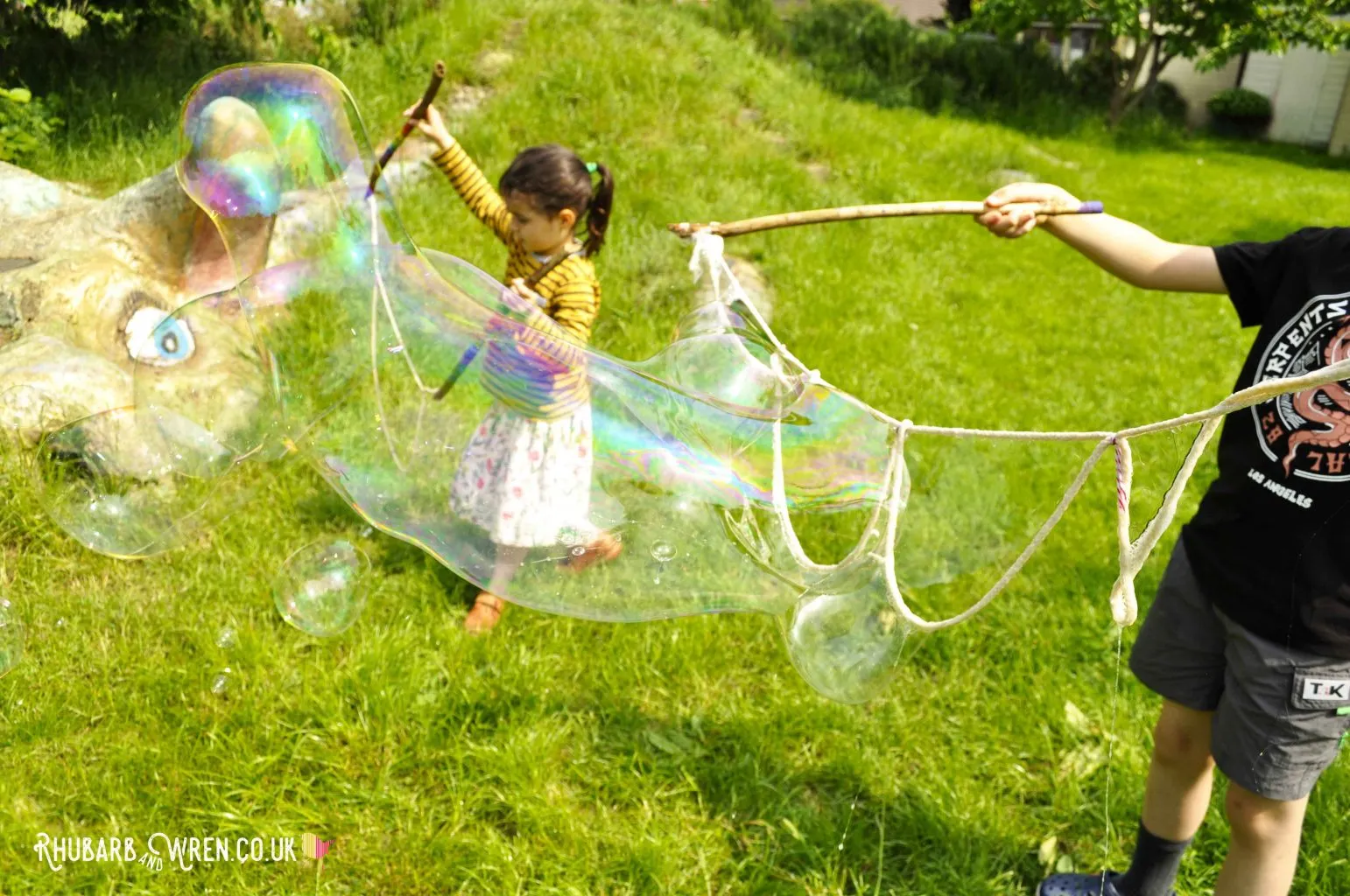 Children making giant bubbles with home-made wands