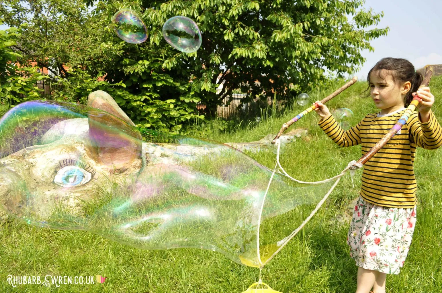 child making bubbles with diy giant bubble wand