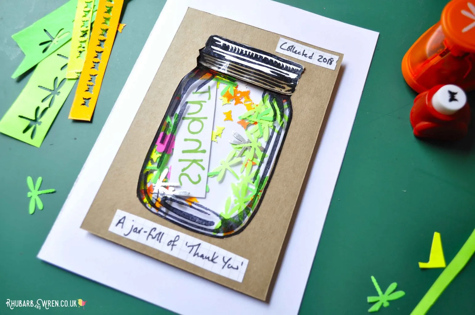 Home-made mason jar shaker card with paper punched shapes.