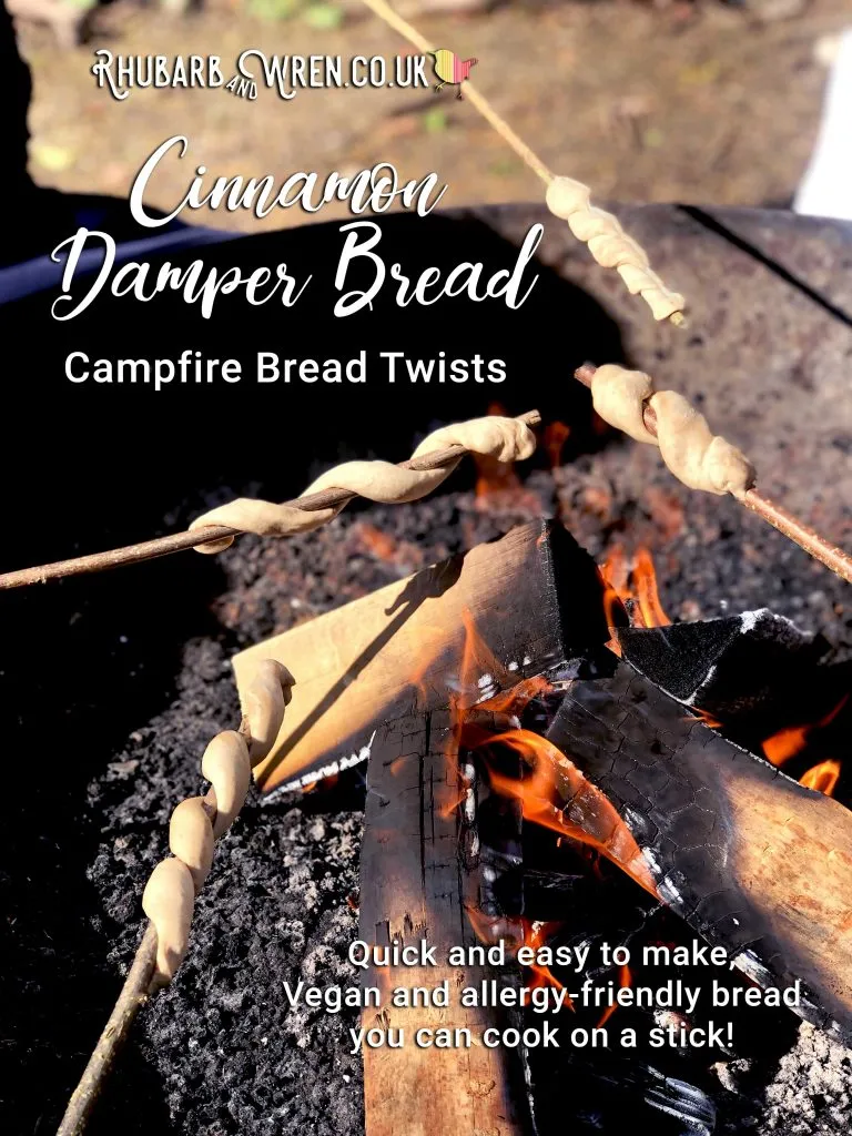 cinnamon damper bread cooked on sticks over a campfire