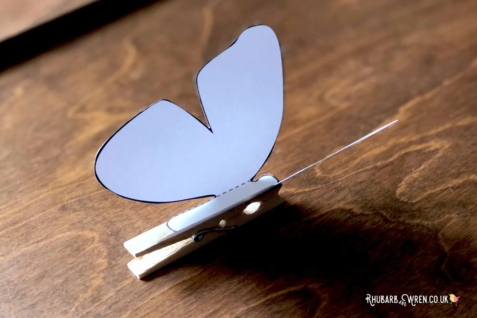 A card butterfly on a peg